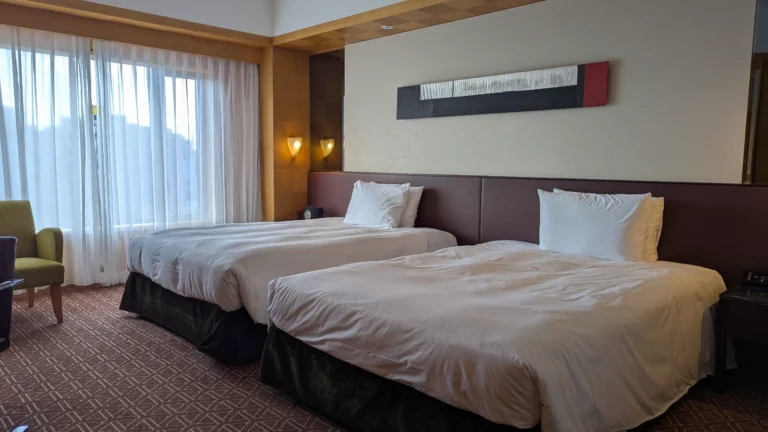 Club twin room at Grand Hyatt Fukuoka with floor-to-ceiling windows, modern Japanese accents, and soft natural light