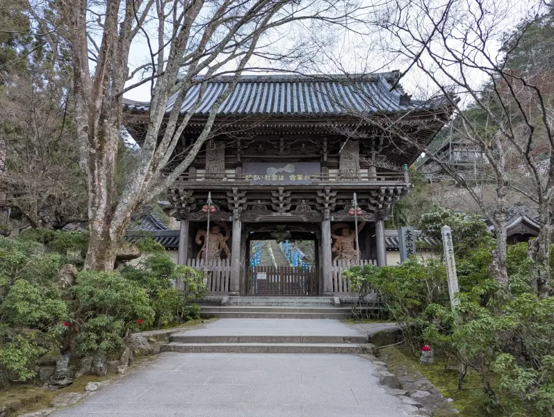 A serene moment at Itsukushima Shrine, with cedar wood corridors floating above the tide. The soft shadows cast by the sun enhance the sacred atmosphere of the site.
