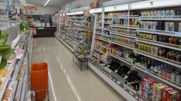 Interior of a Japanese convenience store with shelves of affordable meals and drinks, an essential part of budget travel in Japan.