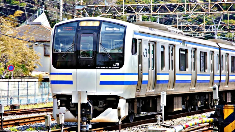 Modern JR train on tracks in Japan, symbolizing easy and efficient travel across the country.