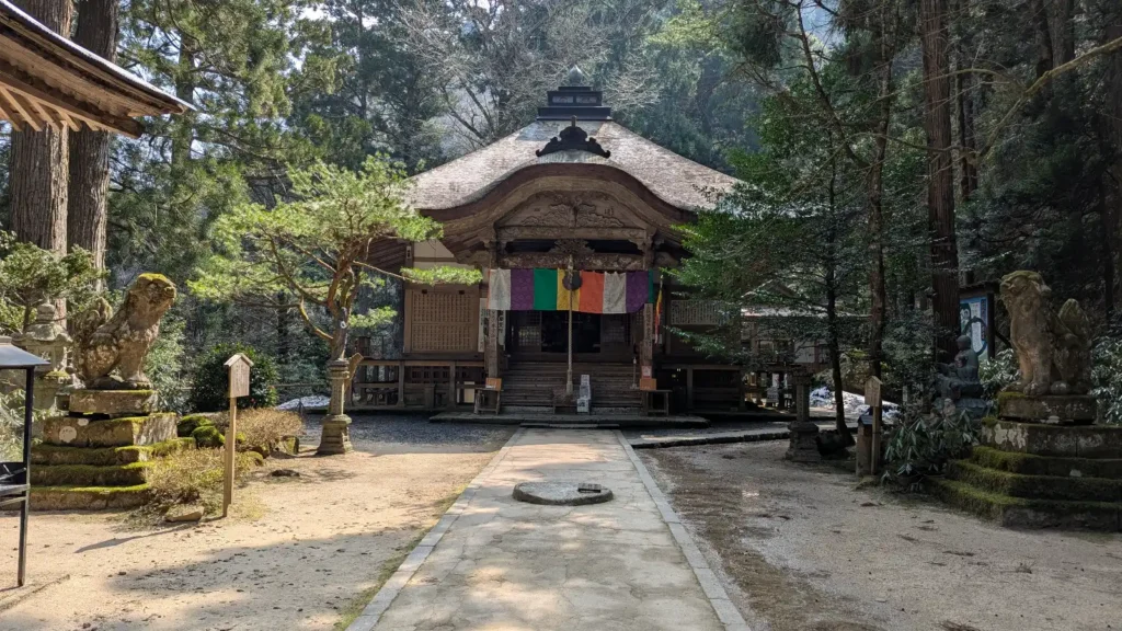 View of the Hondō (Main Hall) of Sanbutsu-ji Temple surrounded by tall cedar trees in Tottori’s Mount Mitoku forest