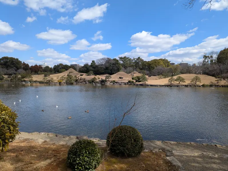 Off the beaten path Kumamoto: Peaceful pond reflection at Suizenji Jojuen Garden, showcasing Kumamoto’s natural beauty and quiet landscapes.