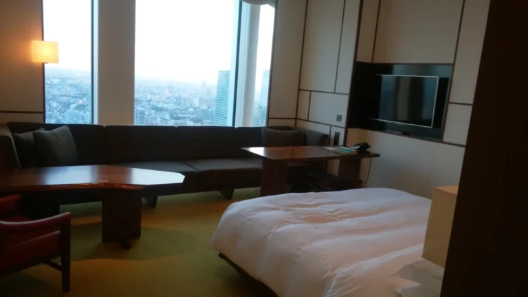 Panoramic view from a minimalist Tokyo hotel room overlooking the city skyline